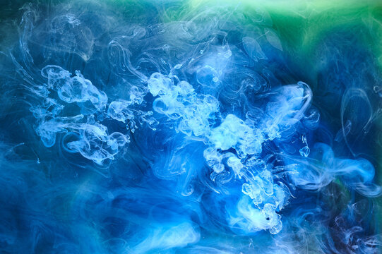 Blue green smoke on black ink background, colorful fog, abstract swirling ocean sea, acrylic paint pigment underwater