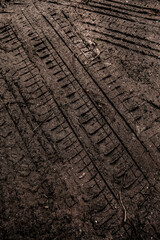 Tyre track on dirt sand or mud, Picture in retro or grunge tone. Car drive on sand. off road track. Track on grass field. Track in farm.	