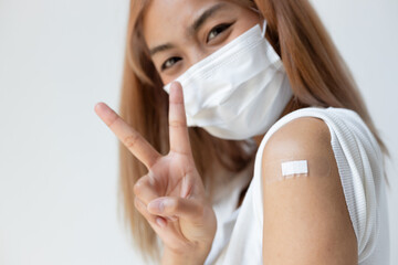 Healthy and strong asian woman getting vaccinated immunity by vaccination program, concept of recommended dose of inoculation, vaccine booster shot, vaxxed woman with approved vaccine