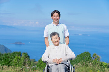 介護士と車椅子に乗る高齢者　屋外ポートレート