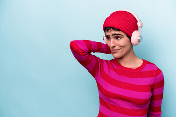 Young caucasian woman listening to music isolated on background touching back of head, thinking and making a choice.