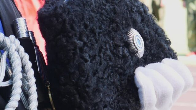 Close up of cossac holding his hat. Part of military uniform