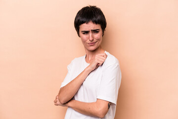 Young caucasian woman isolated on beige background confused, feels doubtful and unsure.