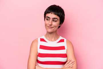 Young caucasian woman isolated on pink background dreaming of achieving goals and purposes