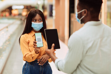 Worker Scanning Visitor's Qr Code On Entrance To Public Place