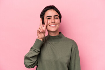 Young caucasian woman isolated on pink background showing number two with fingers.