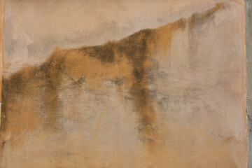 yellow cement wall with water stains.