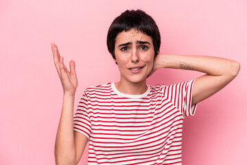 Young caucasian woman isolated on pink background screaming with rage.