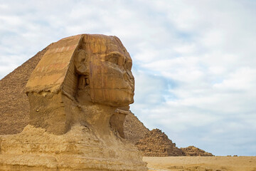 Closeup view of the Sphinx, ancient Egyptian limestone statue of a mythical creature with a lion's body and a human head. It is located  on the Giza Plateau, the Pyramid Complex near Cairo, Egypt