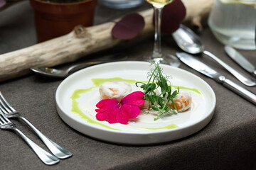 A dish of fish balls in a creamy sauce served on a table in a restaurant