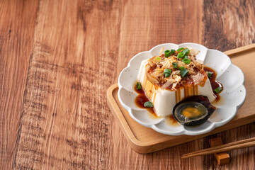 Delicious Chilled tofu and century egg with soy sauce and bonito flakes.