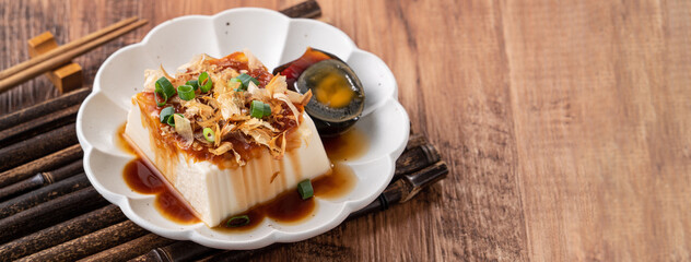 Delicious Chilled tofu and century egg with soy sauce and bonito flakes.