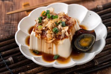 Delicious Chilled tofu and century egg with soy sauce and bonito flakes.