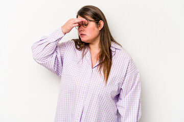 Young caucasian overweight woman isolated on white background having a head ache, touching front of the face.