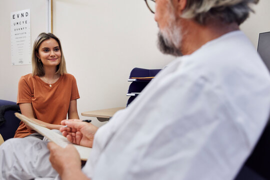 Doctor talking to patient in doctor's office