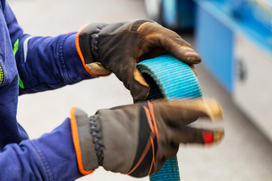 Hands holding blue rope