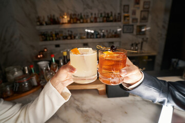 Fragment photo of unrecognised people joining glasses with beverages