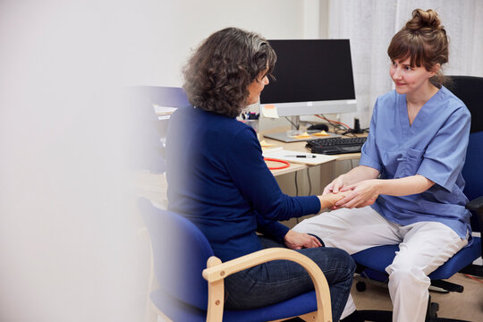 Doctor examining patient's wrist during appointment