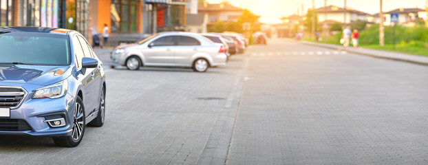 Front view of new car parked on city street side