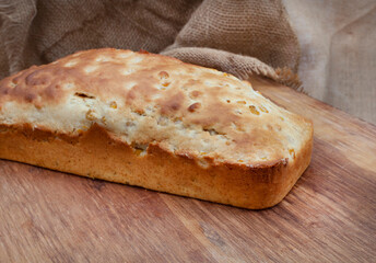 Mielie bread, a South African bread with whole sweetcorn on rustic wooden kitchen table with copy space
