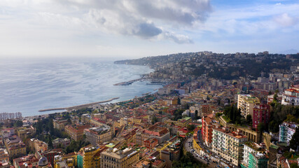 Obraz premium Aerial view of the city of Naples and the seafront of Mergellina on a sunny day. The Posillipo district in the background.