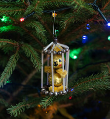 Vintage christmas tree ornament on the pine tree with light garland