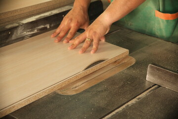 wood cut and hand detail of a carpenter