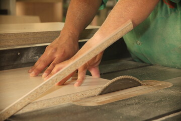 wood cut and hand detail of a carpenter