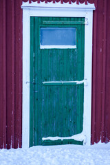 Turquoise door on red wall