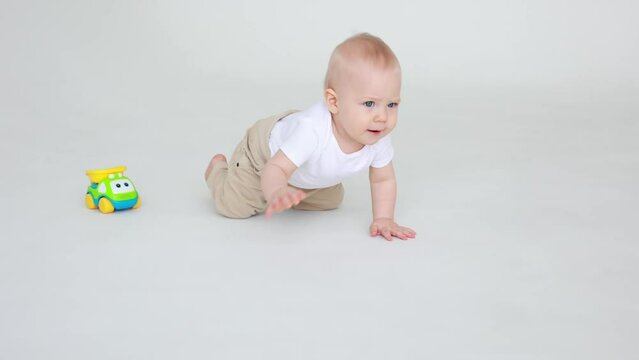 cute baby boy crawling on a white background isolated