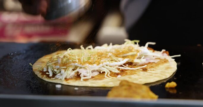 A Chef making Vegetable Frankie, Kathi Roll, Cheese Franky, Veg Wrap. Adding Sauces, Mayonnaise and Spice Masalas to Cabbage Salad and Indian Refined Flour Flat bread. Mumbai, Maharashtra, India. 4809