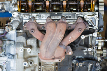 Old exhaust manifold on engine.exhaust pipe repair.Header Engine.