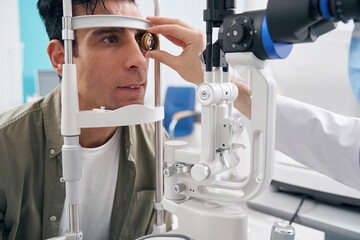 Adult man having medical eye examination in hospital