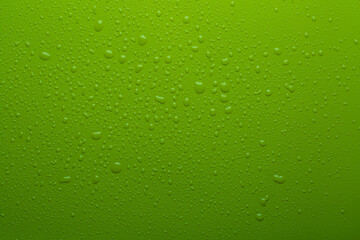 Fototapeta na wymiar Water drops on green color surface
