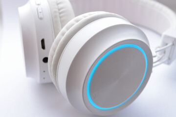 White wireless headphones on white background close up
