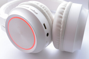 White wireless headphones on white background close up