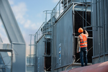 Engineer under checking the industry cooling tower air conditioner is water cooling tower air...