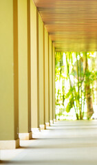 The pillars of the green building have light passing through.