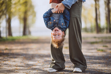 Obraz premium Mother with her little son having fun in park