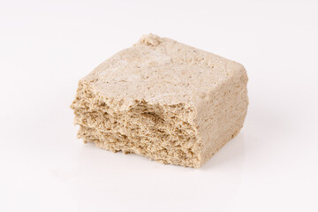 halva with crumbs on white background