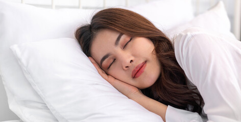 Obraz na płótnie Canvas Portrait of cheerful beautiful pretty asian woman clean fresh healthy white skin sleeping and close eye.Girl felling relaxing and enjoy time on the bed at home.asia beauty