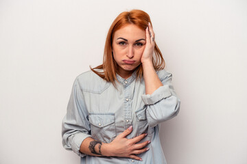 Young caucasian woman isolated on white background blows cheeks, has tired expression. Facial...