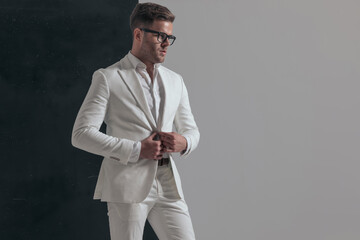 young fashion model opening his jacket, looking to side