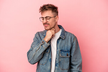 Young caucasian man isolated on pink background suffers pain in throat due a virus or infection.