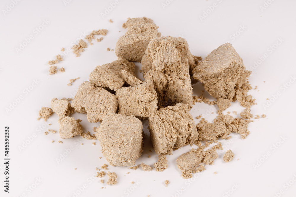 Poster a large pile of pieces of halva on a white background