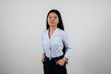 Young woman in a white shirt posing isolated on a white background