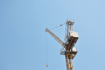 heavy crane for construction building hanging in sky background