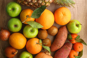 Naklejka na ściany i meble Various healthy fruit and vegetable on wooden background. Top view.