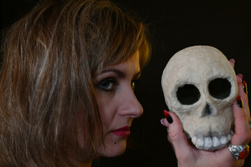 portrait of a witch woman with a skull in her hand