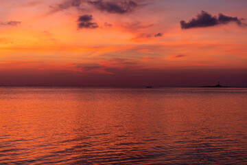 Beautiful sunset over the sea water on the island of Koh Phangan, Thailand. Travel and nature concept